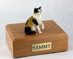 Cat sculpture on wood cremation box